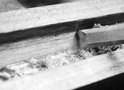 Fig. 7. A regular straight chisel makes a good scraper for deepening the channel where the inletting black shows high spots.